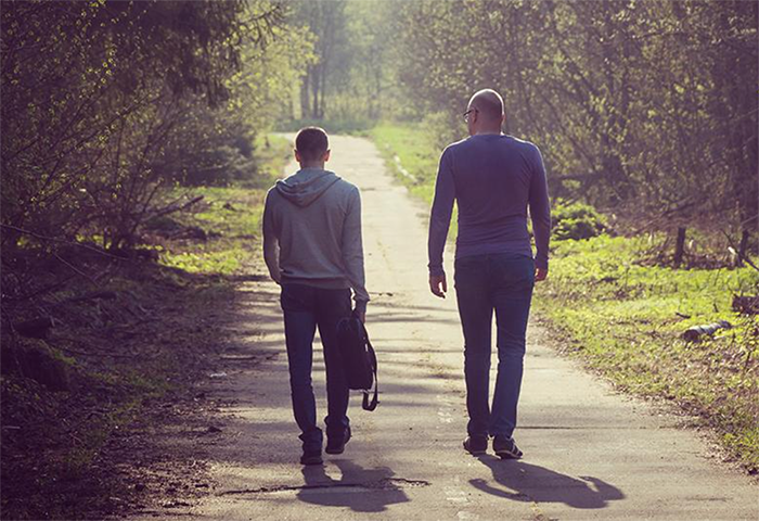 Two men walking down path