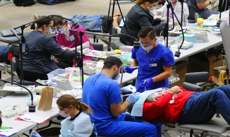 Kansas Dental clinic event in Salina, Kansas. Several dentists and patients in dental chairs.