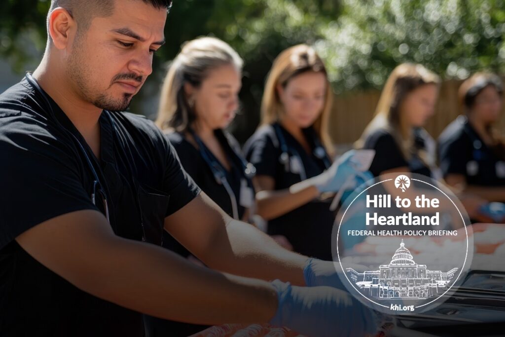 A group of focused healthcare workers prepares materials at an outdoor setup during a “Hill to the Heartland” federal health policy event, with a branded logo displayed in the image.