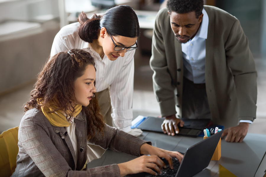 Photo of people looking at a laptop