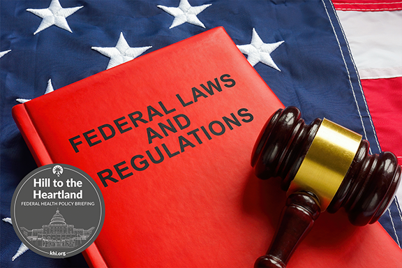 Federal Laws and Regulations stamped on the front of a red book, which is laying on top of a flag along with a gavel.